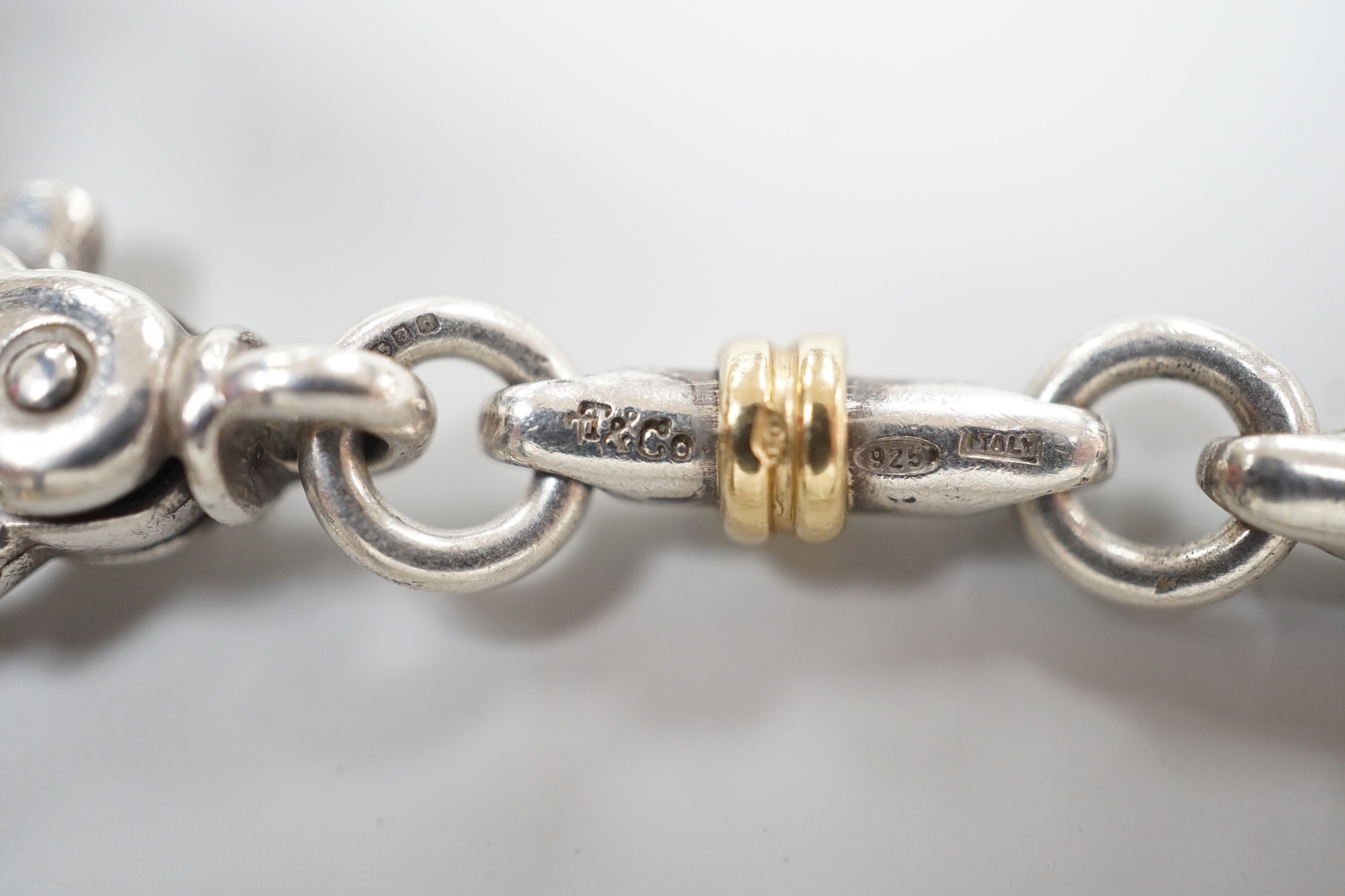 A modern Italian Tiffany & Co 750 yellow metal and 925 white metal, circular and baton link bracelet, 18cm.